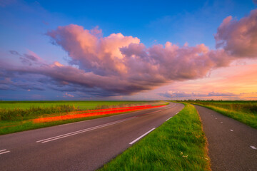 Landscape during sunset with road and clouds. A beautiful asphalt road with sky during sunset....