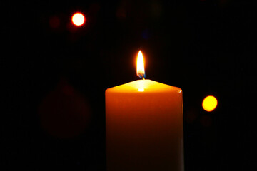 Christmas candle on the background of a beautiful Christmas tree.