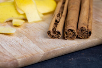 Sticks of real cinnamon on a board with apples