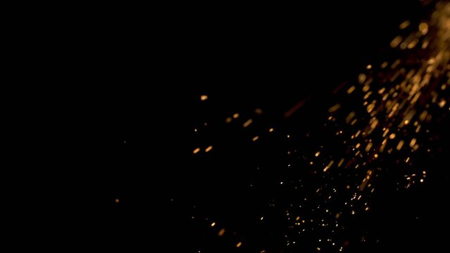Burning red hot sparks rise from large fire seamless loop. Background of bonfire, light and life. Fiery orange glowing flying ember particles on black background Professional footage 4k