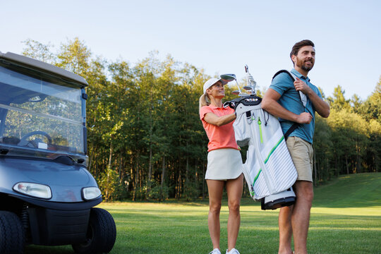 Couple's Golf Outing: Woman Picking Club from Bag