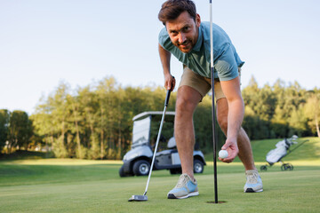 Closing Moments: Golfer Retrieves Ball