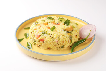 Upma made of samolina or rava upma, most famous south indian breakfast item which is arranged in a black plate and garnished with fried cashew nut and curry leaves 