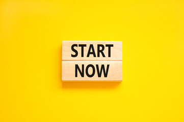 Start now symbol. Concept words Start now on beautiful wooden block. Beautiful yellow table yellow background. Business marketing, motivational start now concept. Copy space.