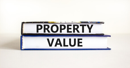 Property value symbol. Concept words Property value on beautiful books. Beautiful white table white background. Business property value concept. Copy space.
