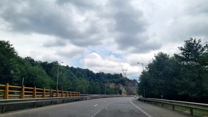 Landscape of road and tree with cloudy sky