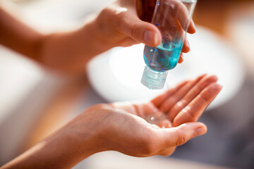 Close up woman using antibacterial hand sanitizer