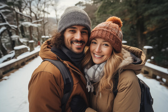 Happy couple enjoy walking and take a photo during winter holiday trip. Travel and lifestyle concept