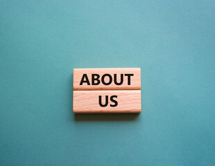 About us symbol. Concept word About us on wooden blocks. Beautiful grey green background. Business...