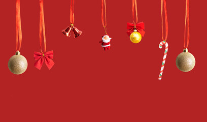 Christmas celebration holiday banner template greeting card panorama - Group of hanging gold golden Christmas balls and toys, isolated on red background.