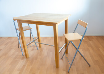 table and two wooden chairs in a furniture store
