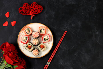 Heart made of fresh sushi rolls with roses, Valentine's Day food, traditional Japanese cuisine,...