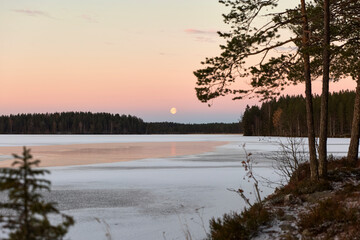 blue hour with moon on the lake
