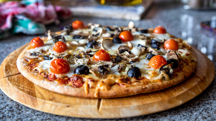 Vegetarian pizza on wooden plate

