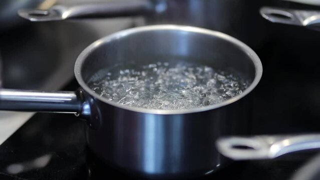 Water boiling,Close-up in pot of boiling water,Bubbles of boiling water. Bubbles of boiling water. Slow motion shot. Slow motion water boiling in pot closeup