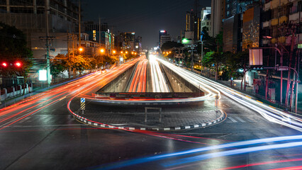 Time-lapse image of an elevated U-turn road. In the middle there were two parallel roads running in...