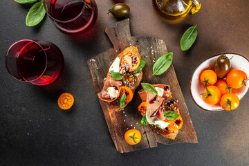 Appetizer crostini, tapas, open faced sandwiches with cherry tomatoes and cream cheese with basil...