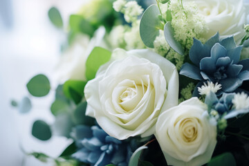 A stunning floral arrangement of white roses and blue succulents, offering a serene blend of color...