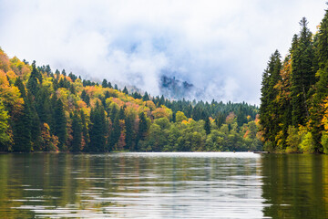 Mountain lake surrounded by colorful autumn trees