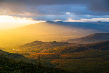 Mountain peaks are illuminated by sunset rays