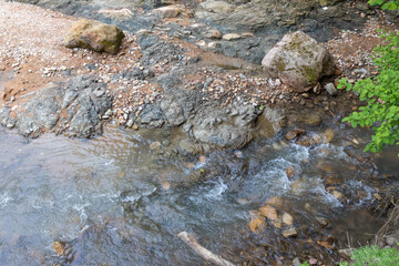 Mountain river spring season with sand and stone shoals along the banks.