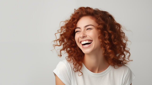 Cheerful, friendly and charismatic redhead woman laughing happily on white background