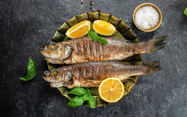 Roasted whole seabass fish with lemon. Delicious fried fish, banner, menu, recipe place for text, top view