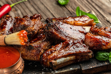 Hot grilled pork ribs with sauce and smoke on a wooden board. Restaurant menu, dieting, cookbook...