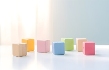 children's toy geometrical cubes on a white wooden table soft li
