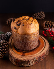 Traditional Italian panettone with chocolate for Christmas on wooden table.