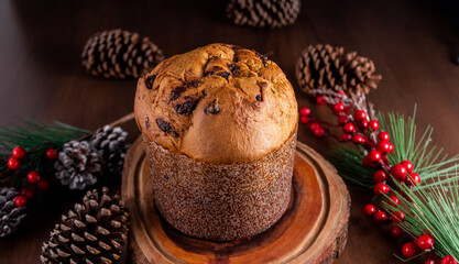 Traditional Italian panettone with chocolate for Christmas on wooden table.