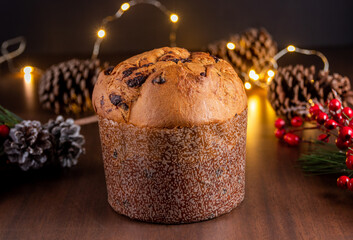 Traditional Italian panettone with chocolate for Christmas on wooden table.