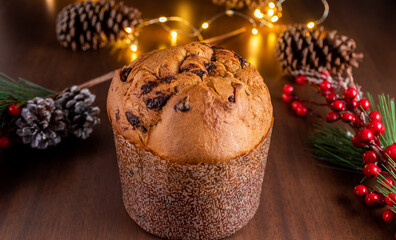 Traditional Italian panettone with chocolate for Christmas on wooden table.