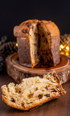 Slice of delicious Panettone with chocolate for Christmas. On wooden table