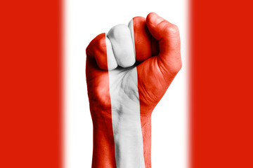 Man hand fist of PERU flag painted. Close-up.
