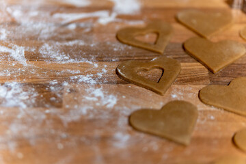 cookie dough with flour as a heart on a wooden table