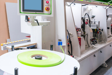 Wood boards on a woodworking machine in a modern furniture factory, woodworking industrial concept background