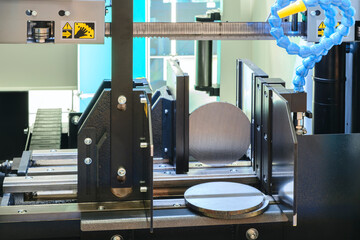 The automatic band saw machine cutting the metal bar with coolant method. The machine tool for industrial purpose.