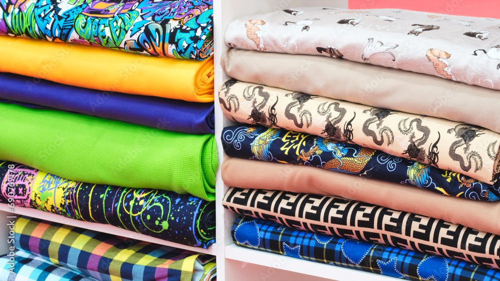 Aufkleber multi-colored patterned fabric lies on pegs in the store