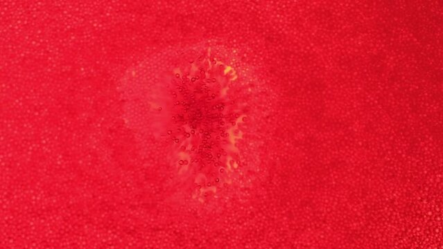 Close-up red bubbles in soda. Macro