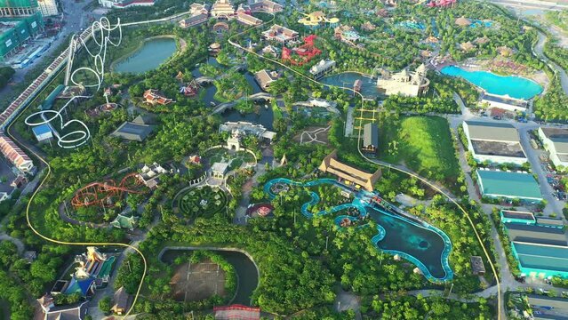 Amusement park, drone and holiday for outdoor fun time, adventure and leisure. Water slide, rollercoaster and tourist attraction for entertainment, urban area and greenery with carousel for summer