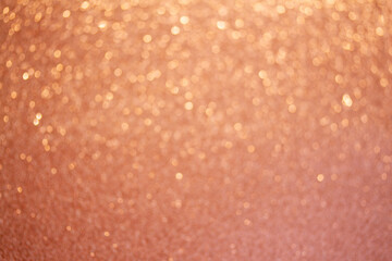Christmas holiday glittering defocused Peach Fuzz background with bokeh lights
