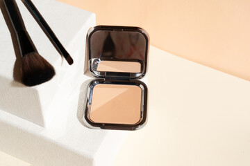 Minimal modern cosmetic scene with make up brushes, powder in the color of Peach Fuzz