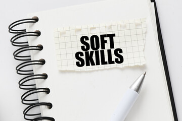 SOFT SKILLS on a piece of paper placed on the notebook. Concept for business.