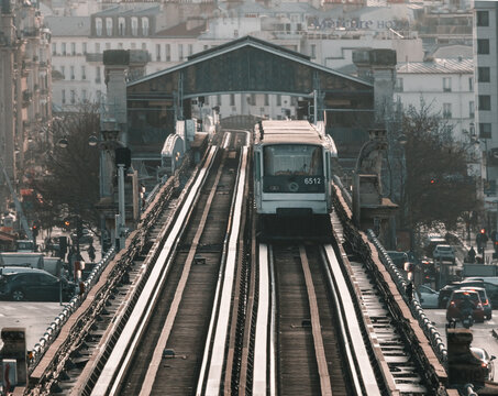 Paris, France: elevated metro line 6 in the evening next to the traffic
