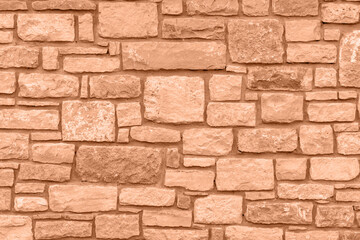 Color of the year 2024: Peach fuzz. Plain stone wall.