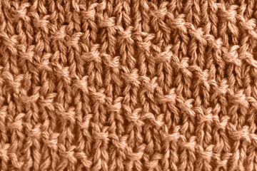 Peach wool knit with diagonal stripes. Color of the year 2024