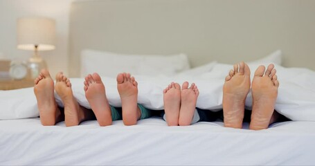 Sleeping, feet and family wake up in a bed with toes, movement and morning energy in their home together. Love, foot and children awake with parents in a bedroom for nap, dreaming or resting in house