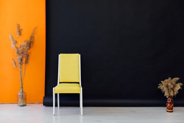 Yellow chair in black orange room interior