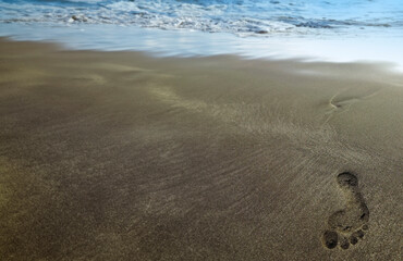 beach with one footstep - holiday background